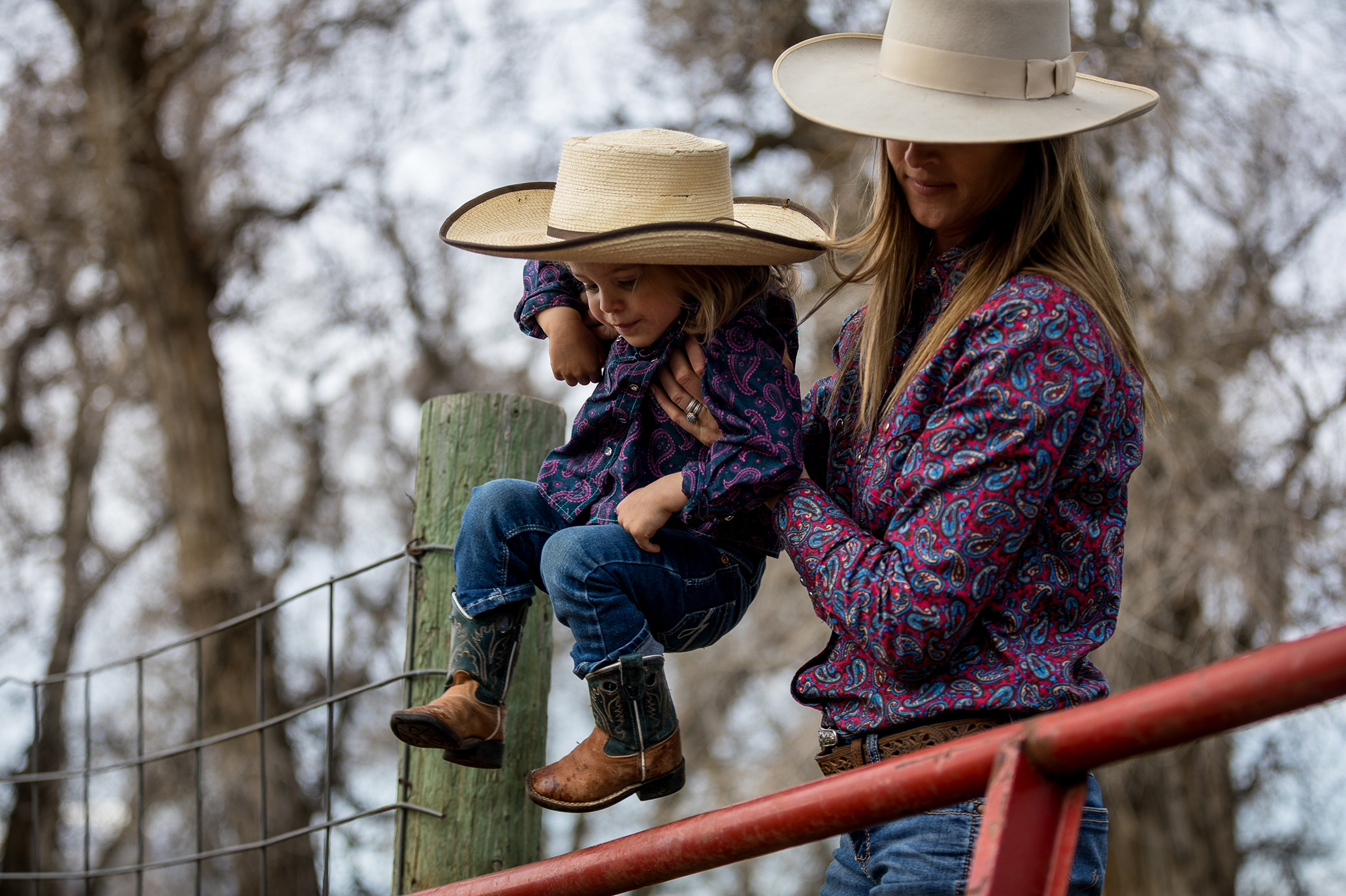 Setting her child over the fence.