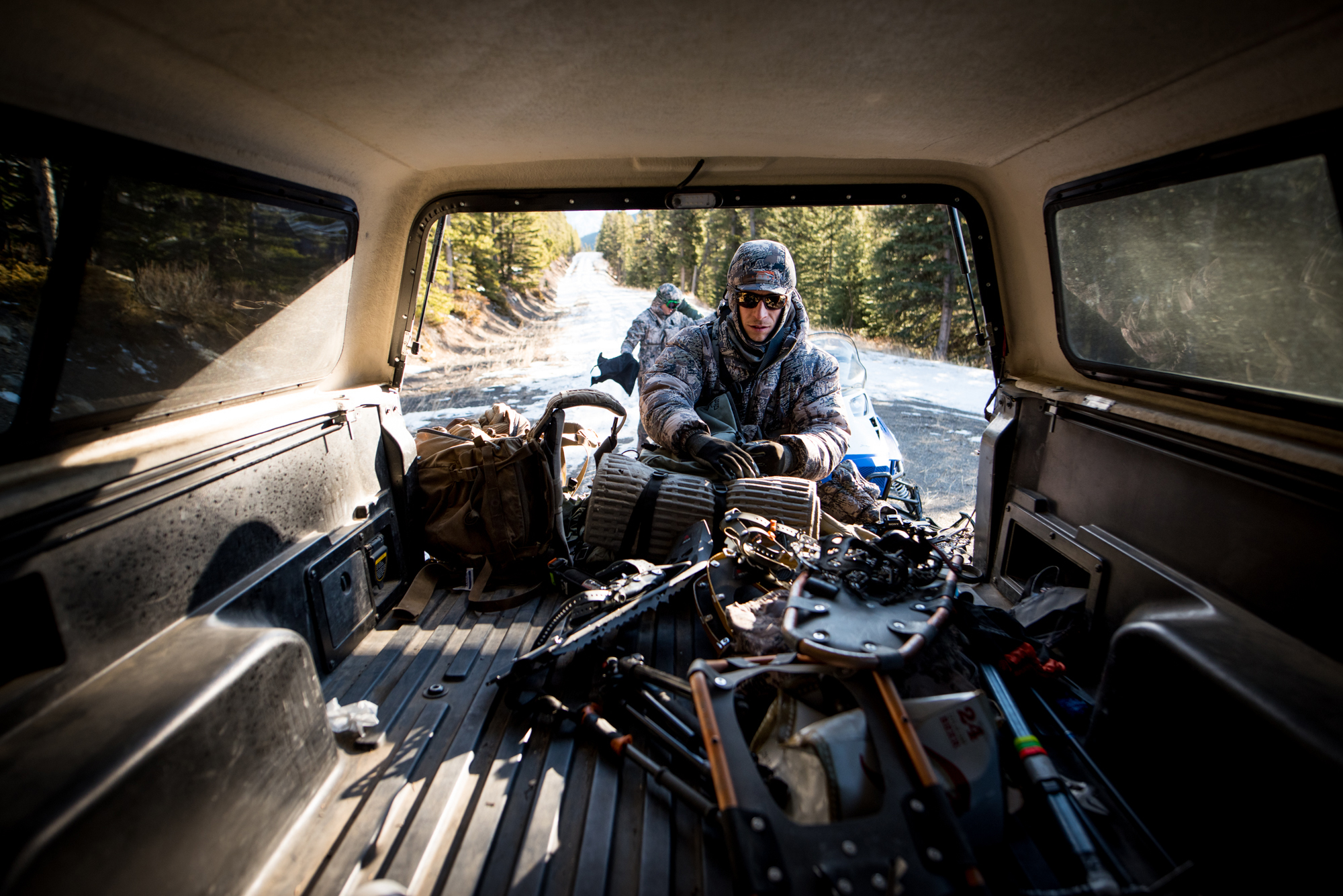 Adam Foss unloads his hunting gear from the bed of a truck.