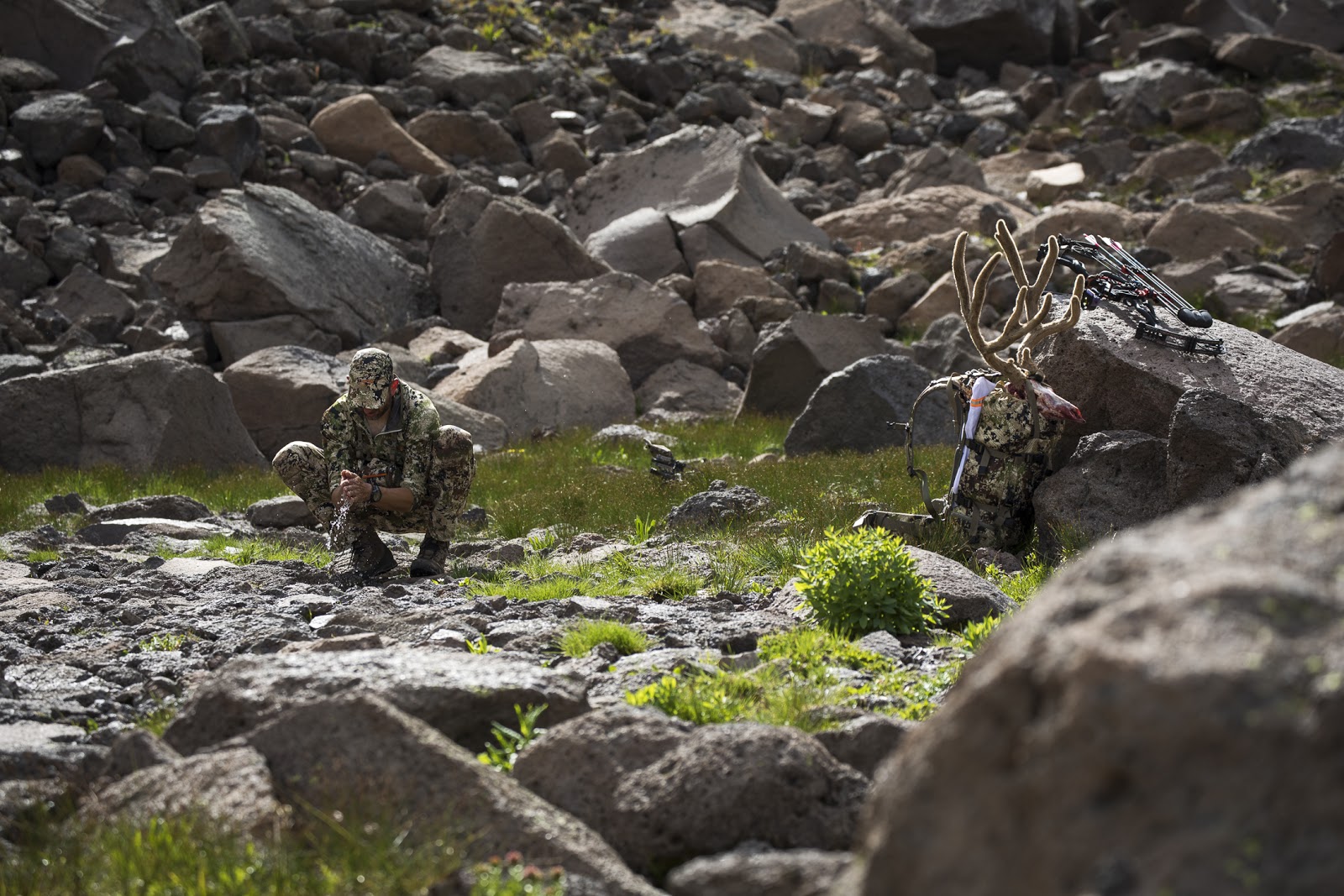 A hunter washes his hands after a successful hunt.