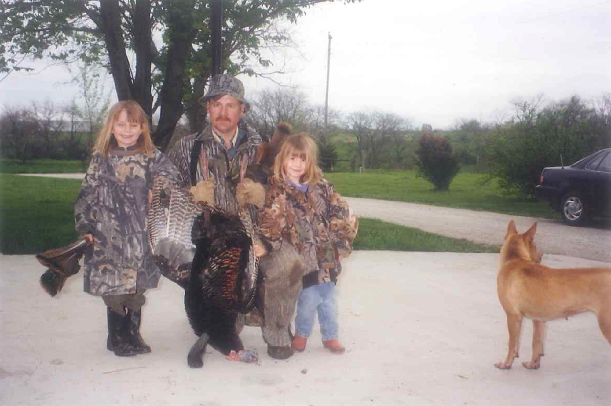 Posing with her first turkey at 6 years old.