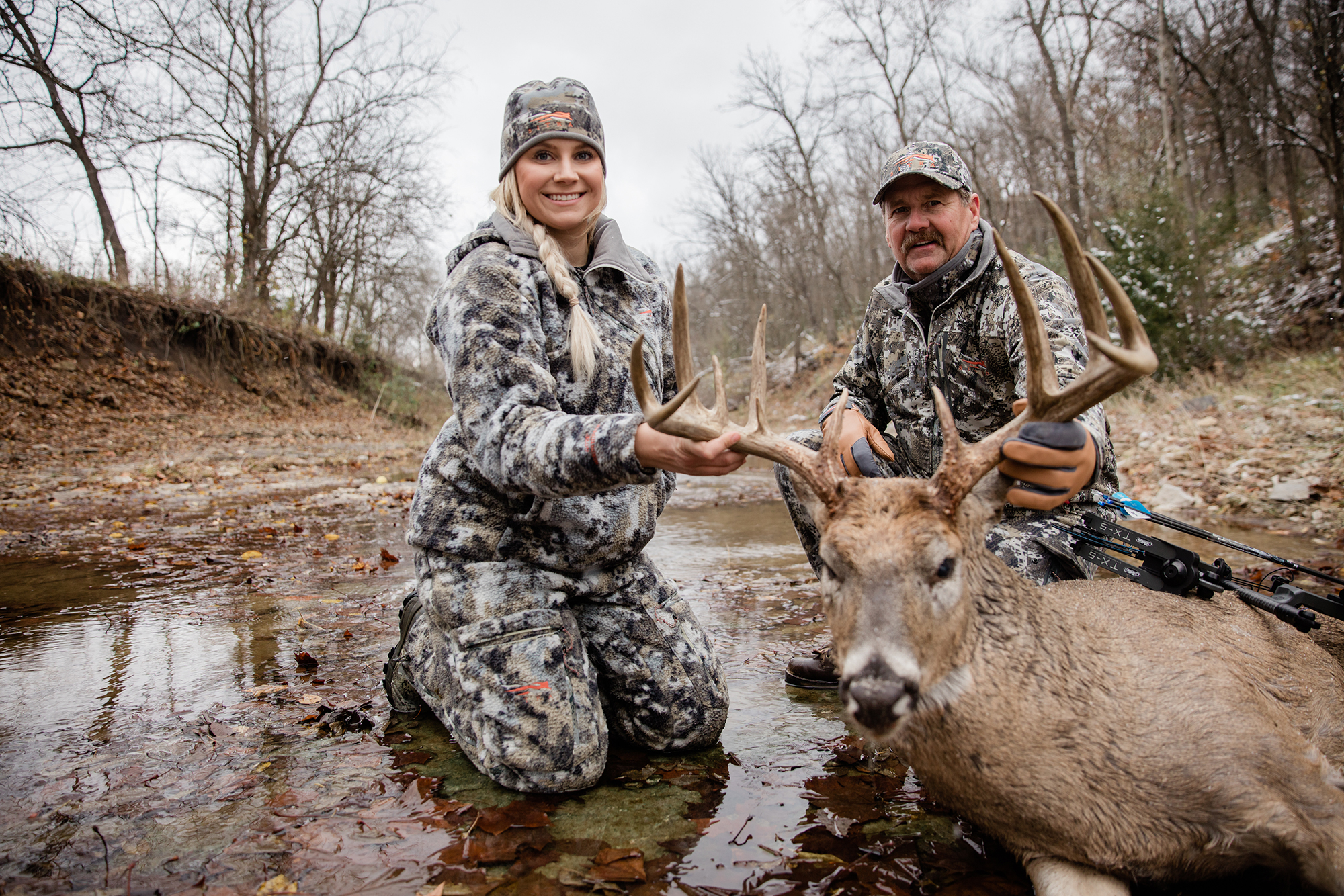 Alex Templeton and her father pose with her archery buck.