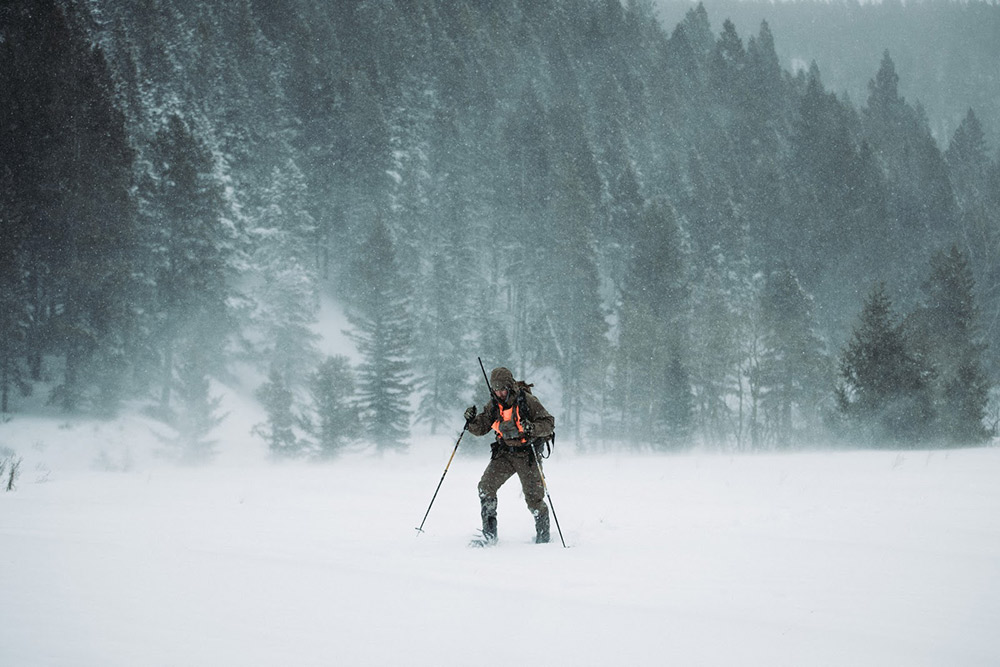 Trekking through snow in late season conditions.