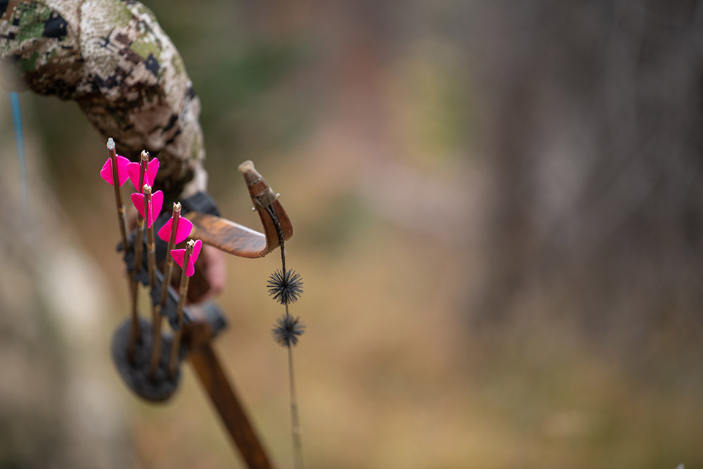 Man carries a traditional bow on a hunt in Colorado.