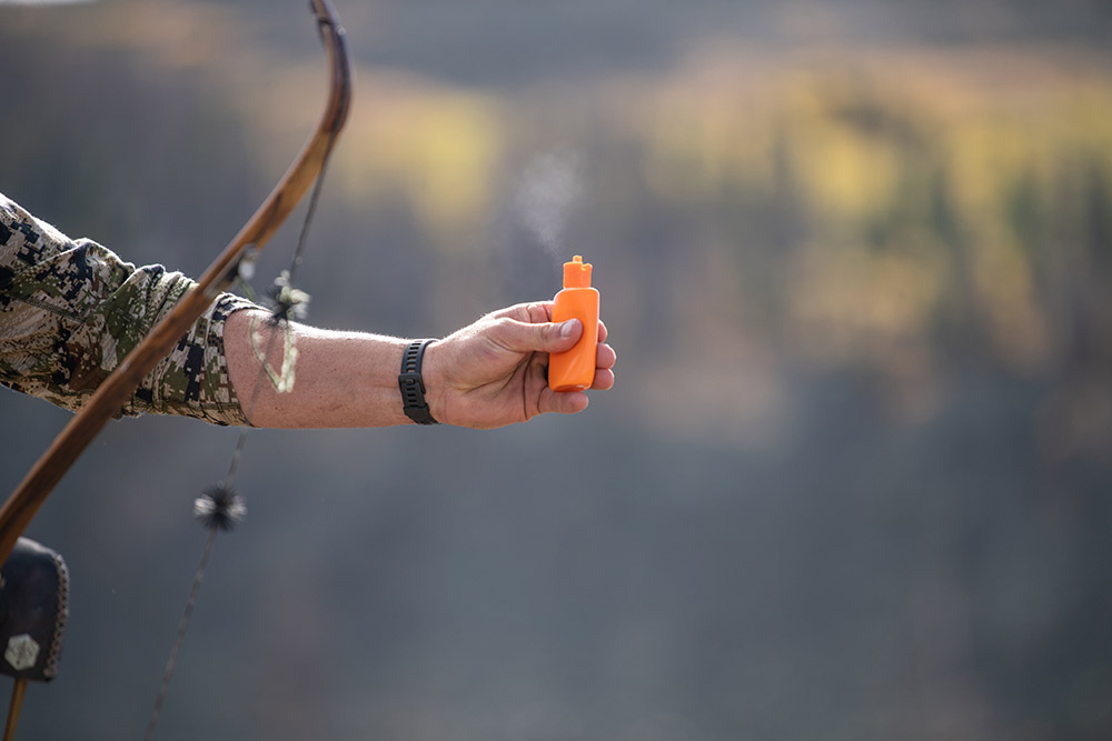 Testing the wind direction with a recurve bow in hand.