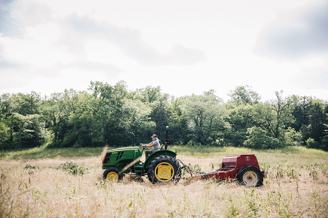 Alex Templeton works her land on a John Deere.