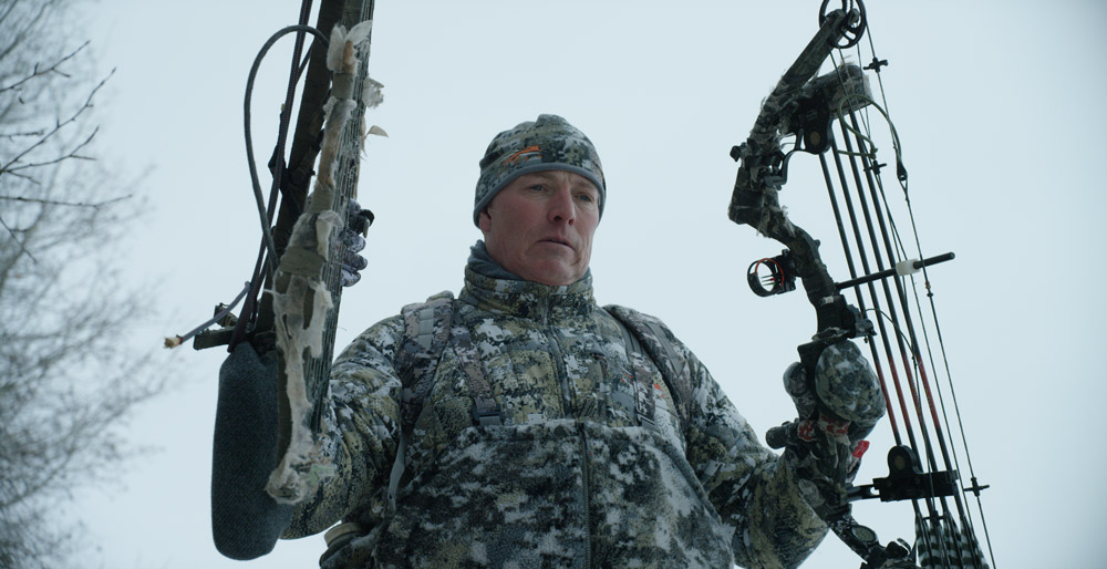 Bowhunter Jim Hole Jr. walks to his stand.