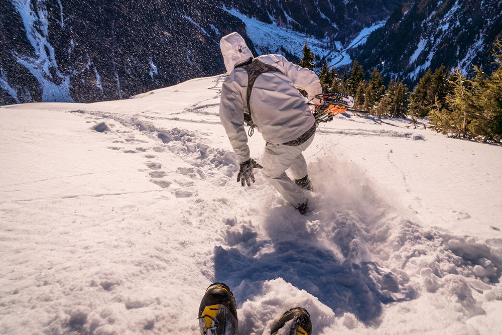 A hunter moves quickly in the snow to attempt to get into range.