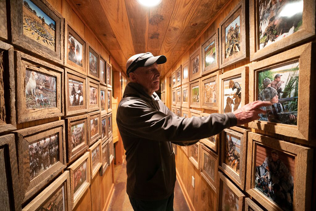 Duck hunter, Ramsey Russell looking at old photos.
