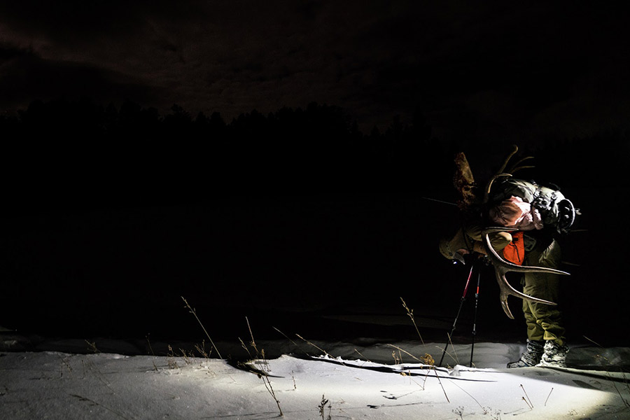 A hunter rests after a heavy pack out.