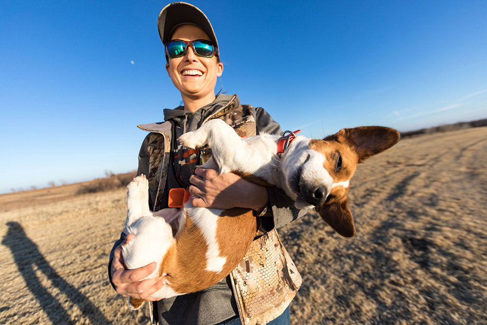 Dog trainer Alex Brittingham holds her Jack Russell Terrier, Gator.