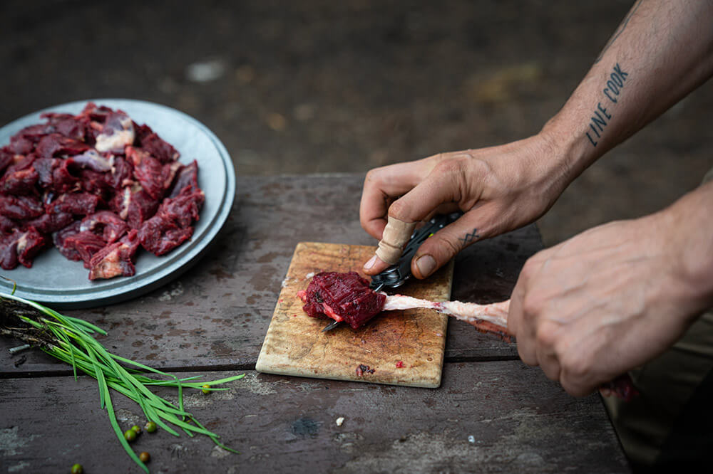 Cook prepares bear meat Cutting bear meat