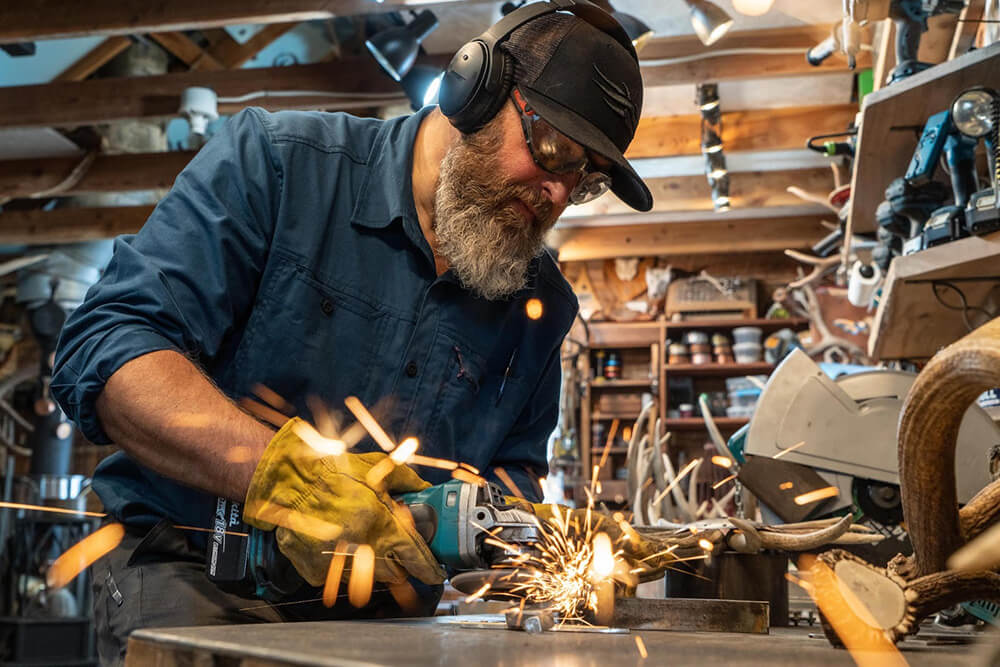 Craig Krzycki welding a piece onto a shed for something extra